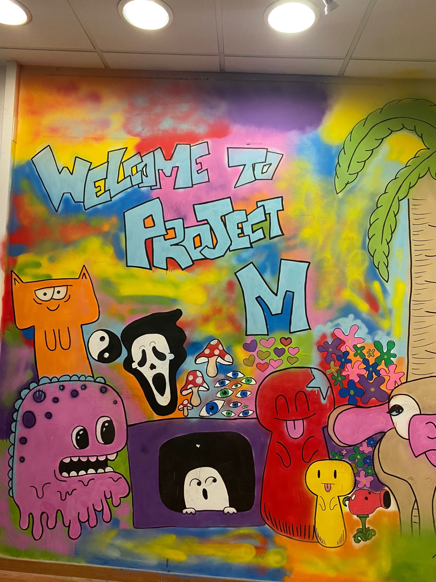 A graffiti-style mural at the entrance to Project M