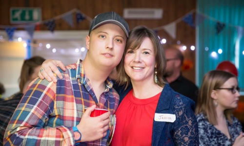 Harry Chadwick wearing a blue baseball cap and checked red shirt with his mum at his 18th birthday party